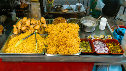 A vibrant Thai and Indian fish market stall with fresh seafood, vegetables, fruits, and a variety of healthy, delicious dishes on display, offering a colorful and appetizing buffet for a healthy meal
