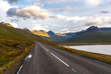A breathtaking landscape unfolds near Breiddalsvík, eastern Iceland, with panoramic views of towering peaks and vast horizons
