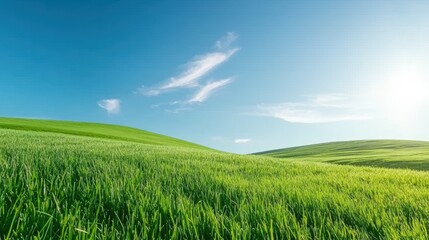 Lush Green Hills Under a Bright Blue Sky with Clouds