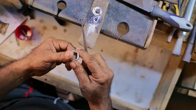 Handmade Jewelry Crafting: Artisan Making a Silver Ring
