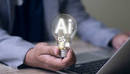 Man's hand with a light bulb And there's a gear icon in there. And he is using a notebook computer. Ideas inspired by online technology Innovative ideas from (AI)