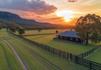 Fototapeta premium Serene Sunset Over Lush Pastureland with Rustic Cabin and Fencing Highlighting Tranquility in Nature's Embrace at Dusk