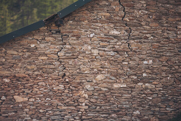 old house with cracks. Stone wall. Ancient architecture. Old Europe. Stone background. French...