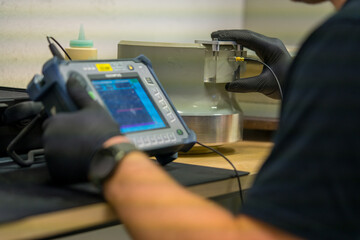 Industrial NDT Inspector Setting Up Ultrasonic Testing Equipment for Quality Control. Technician...
