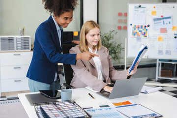 Diverse professionals collaborate on project analysis with financial graphs.
