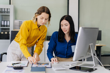 Diverse professionals collaborate on project analysis with financial graphs.