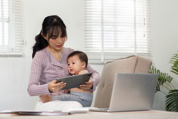 Interactive mother engaging with her baby on a tablet while managing tasks in a home office