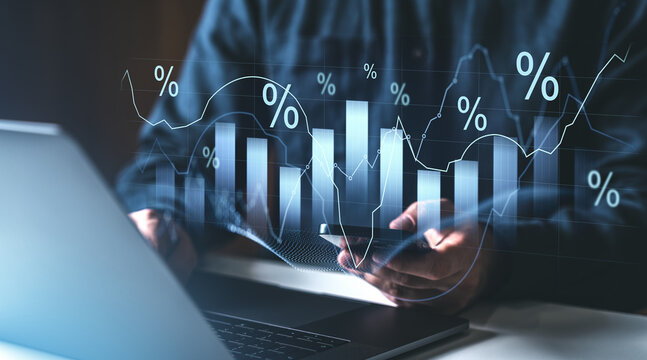 Businessman analyzing financial charts with percentage symbols on digital interface.