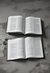 Fototapeta premium A large open book lying flat on the ground with a black and white page exposed, simple, reading material, white