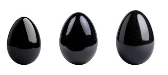 Glossy black eggs with a reflective surface on white background