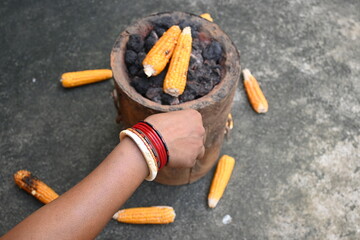 Grilled Sweet corn cob. This is a complete food for humans. It contains many vitamins. Grilled corn cob on coal stove. It's like all over world. Heathy eating. 
