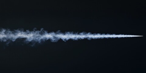 Vapor trail against dark sky - atmospheric science and aerodynamics concept