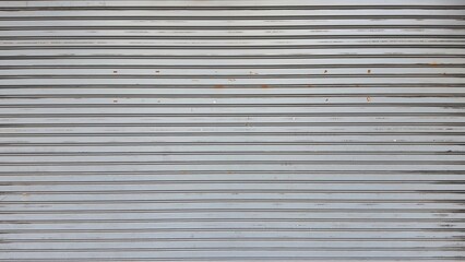 Obraz premium Rolling door. Steel shutter door of warehouse. The shutters are gray metal. Steel rolling shutter background. Silver metal rolling shutter background. Background images and texture images.