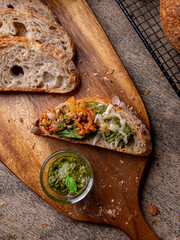 Pesto Sauce with Rustic Sourdough Bread on Wooden Table.