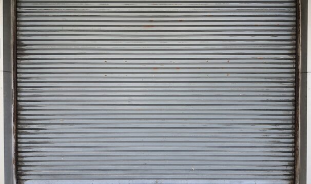 Rolling door. Steel shutter door of warehouse. The shutters are gray metal. Steel rolling shutter background. Silver metal rolling shutter background. Background images and texture images.