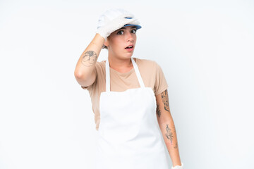Fishmonger wearing an apron and holding a raw fish isolated on white background doing surprise gesture while looking to the side