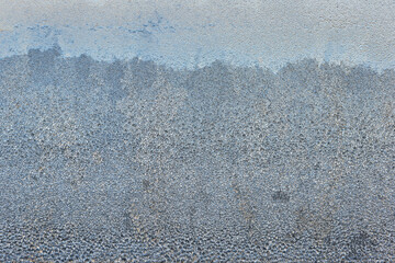 Frost patterns on window glass during a cold winter morning at home creating a serene and quiet atmosphere