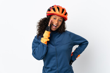 Teenager cyclist woman isolated on white background shouting with mouth wide open