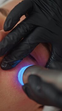 Professional Cosmetologist Performing Hydrafacial Treatment on a Woman Face for Skin Cleansing and Hydration in a Beauty Spa. High quality 4k footage