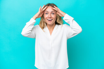 Young Russian woman isolated on blue background with surprise expression