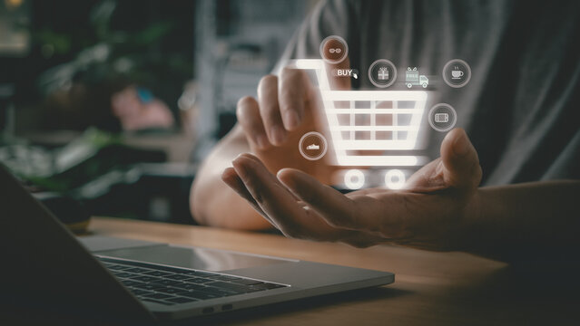 Person hands typing on laptop keyboard, working online for internet shopping with cart infographics