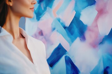 Woman in white shirt admires an abstract painting with blue and pink hues.