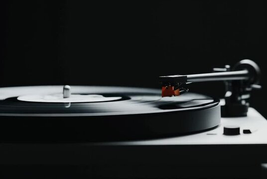 Vinyl record player needle placing on rotating disc in dark room