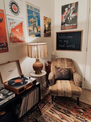 Cozy vintage corner with a record player, armchair, lamp, and posters