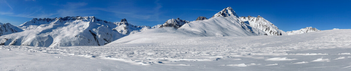beautiful panoramic view on snowy mountain range  in French alps in Tarentaise under blue sky