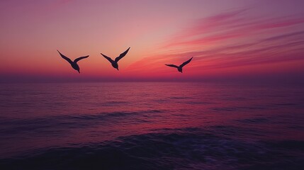 Obraz premium Birds flying over ocean at sunset, vibrant sky, peaceful scene