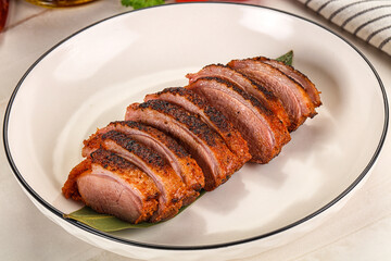 Sliced duck breast baked with cherry