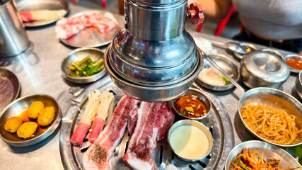 Traditional samgyeopsal restaurant dining with fresh ingredients and side dishes
