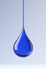 Fototapeta premium A vivid blue liquid droplet suspended against a soft background, capturing the beauty of fluid dynamics and color.