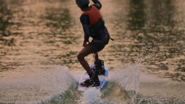 Wakeboarding at Sunset with Water Splashes