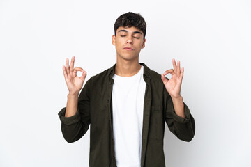 Fototapeta premium Young man over isolated white background in zen pose