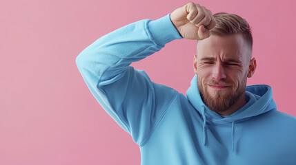 Naklejka premium Energetic man expressing joy with playful gesture against pink background