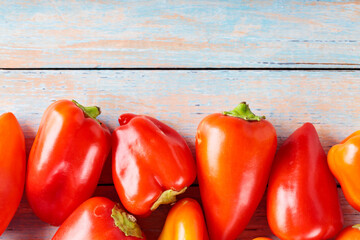 Red and Orange Bell Peppers on Wooden Background for Healthy Farm-Fresh Nutrition, Top View, Copy Space