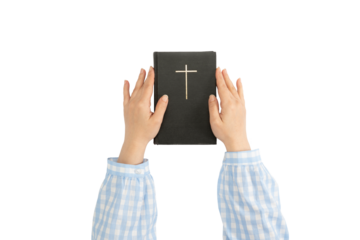 Hands holding Holy Bible. Cross on a dark cover book. Sacred scripture. Isolated background