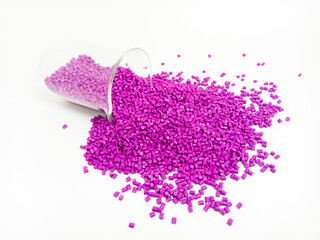 Pink masterbatch plastic granules, polymer carries pigment in glass tube poured with white background, suitable for product catalog design of plastic manufacturing industry company profile
