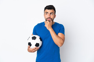 Handsome young football player man over isolated wall having doubts and thinking