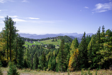 View of a mountain valley with a small village from the top of the mountain