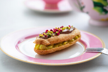 Elegant pistachio and raspberry eclair