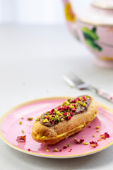 Elegant pistachio and raspberry eclair