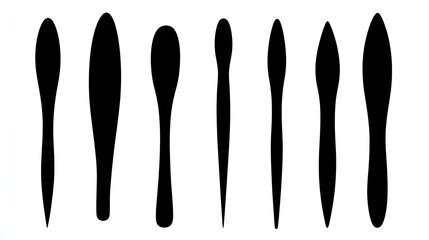 Set of simple, flat black silhouette shapes. Long oval shape with a pointy tip at one end and a rounded base on the other, against a blank background. High resolution. 