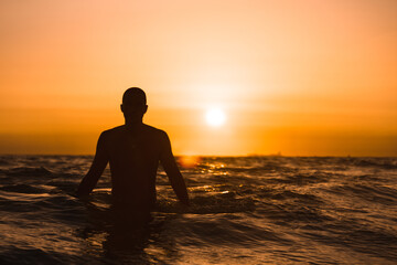 Fototapeta premium Silueta de hombre en el mar al atardecer 