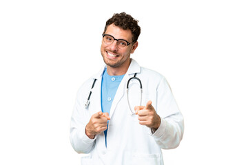 Fototapeta premium Brazilian doctor man over isolated chroma key background pointing to the front and smiling