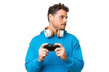 Brazilian man playing with a video game controller over isolated chroma key background looking to the side