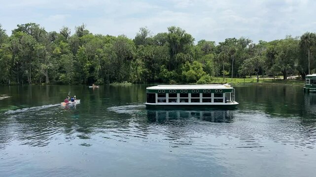 Tourist boat and kayak at Silver Springs, Florida