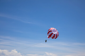 Parachute dome against blue sky. Sunny day.