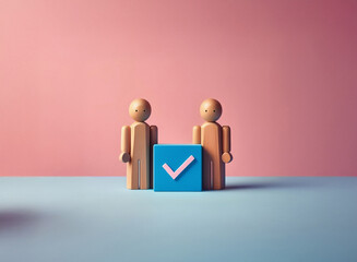 Grainy textured image of two light brown wooden figurines standing beside a teal cube displaying a pink checkmark against a muted pink and blue background.  The scene has a minimalist, almost toy-like